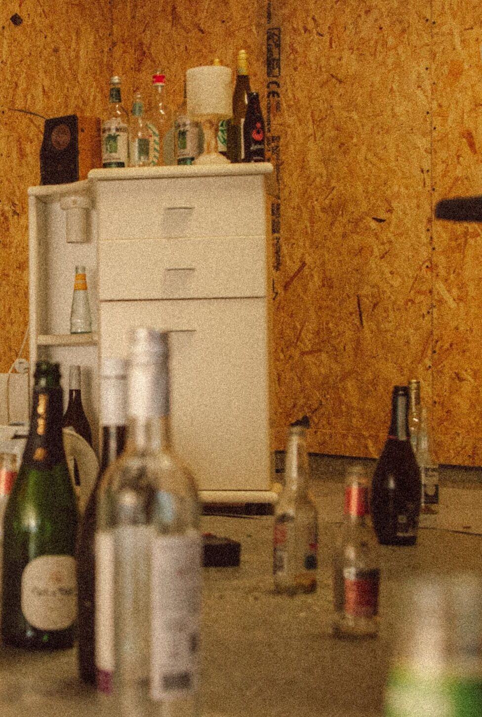 Rage room bottles and breakables on concrete floor